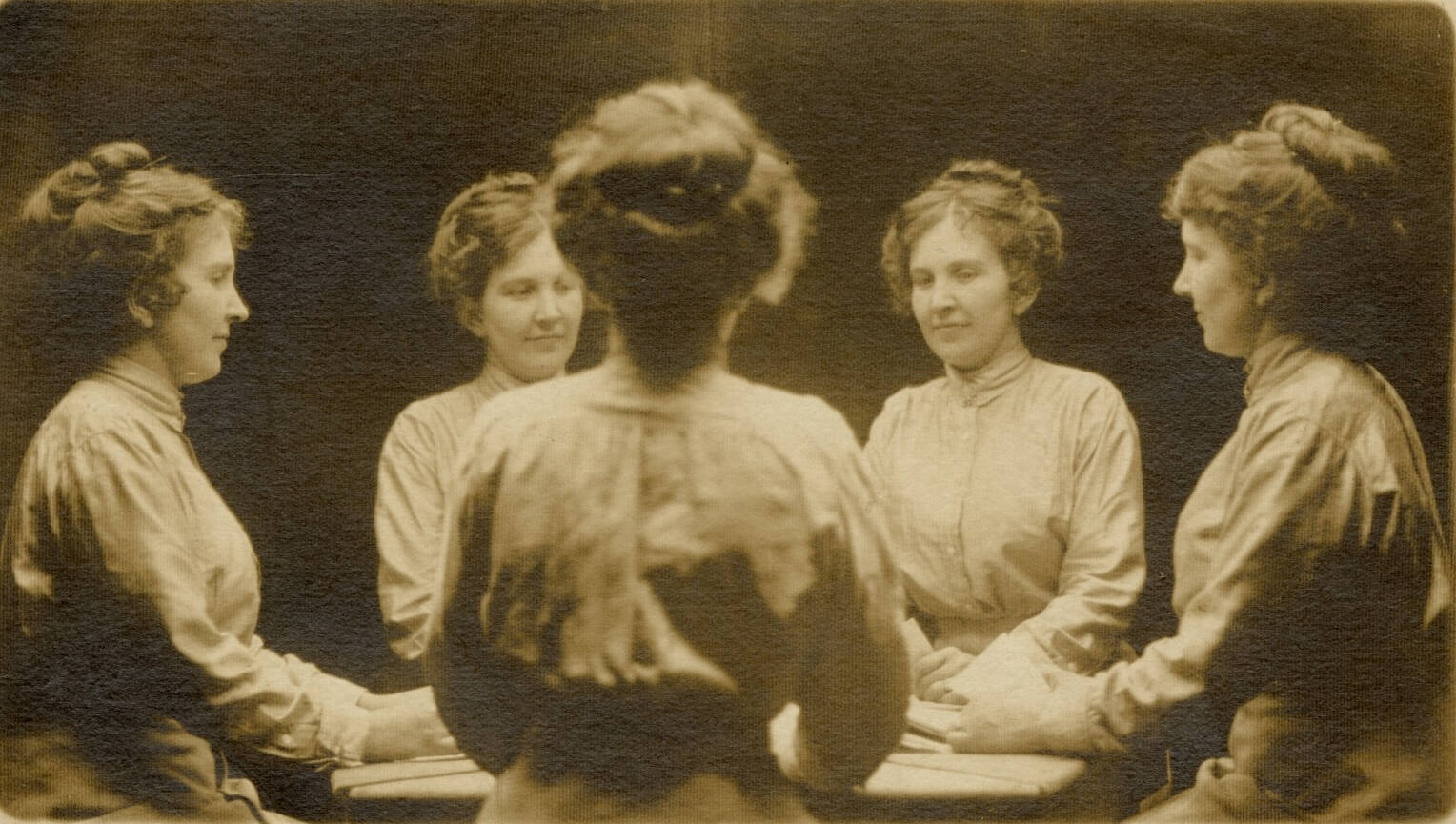 Black and white real photo postcards of women seated in a circle- or is it the same woman reflected?